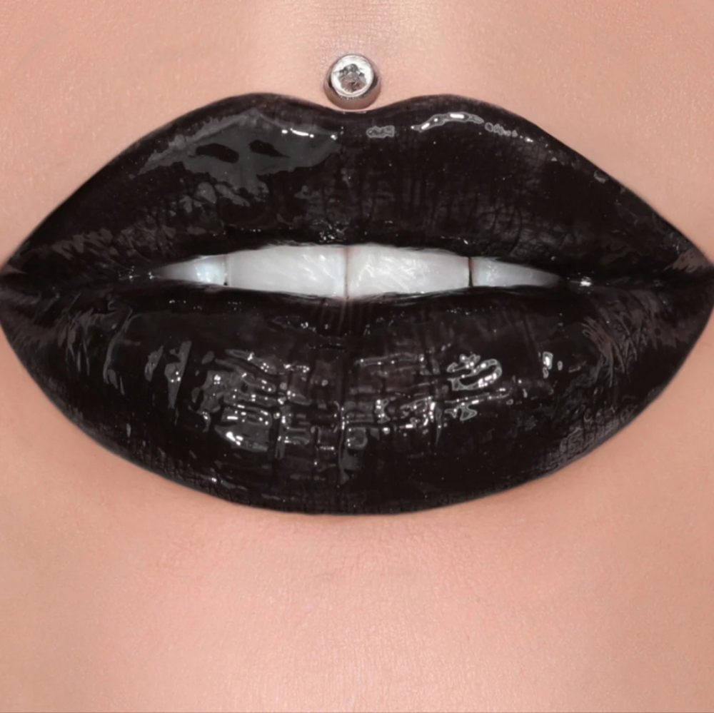 F*king Freak jeffree star supreme gloss in a dark purple/Black